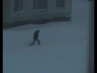 guys jump from the roof of the house into a snowdrift.